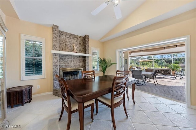 dining area with ceiling fan, vaulted ceiling, light tile patterned floors, and plenty of natural light