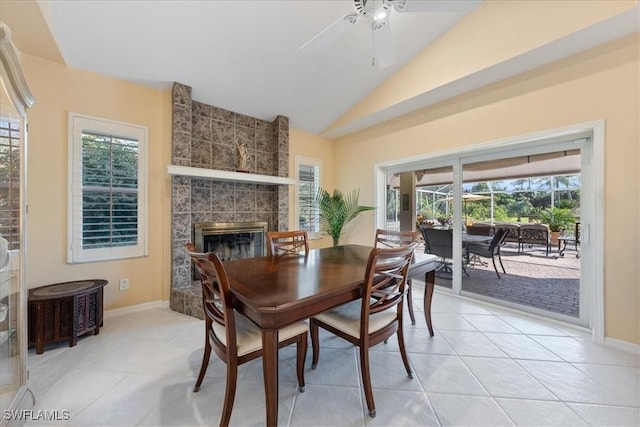 dining area featuring light tile patterned flooring, ceiling fan, vaulted ceiling, and a healthy amount of sunlight