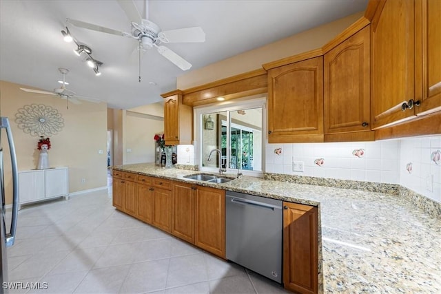 kitchen featuring light stone counters, dishwasher, light tile patterned floors, ceiling fan, and sink