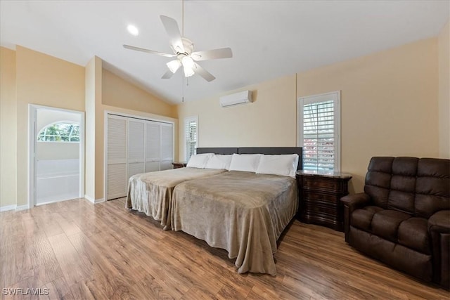 bedroom with ceiling fan, a wall mounted AC, a closet, and multiple windows