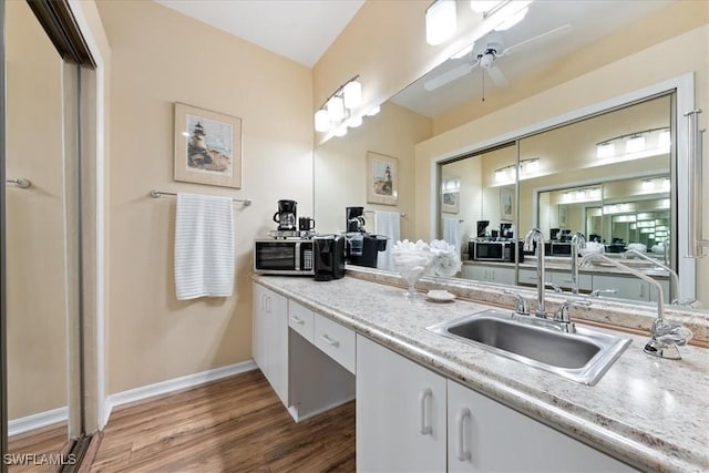 bathroom featuring vanity, hardwood / wood-style floors, and ceiling fan