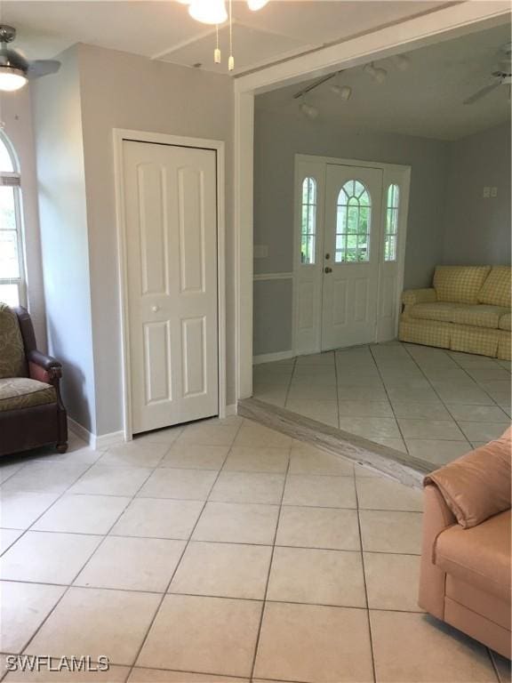 entryway with ceiling fan and light tile patterned floors