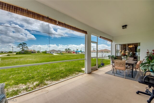 unfurnished sunroom with a chandelier