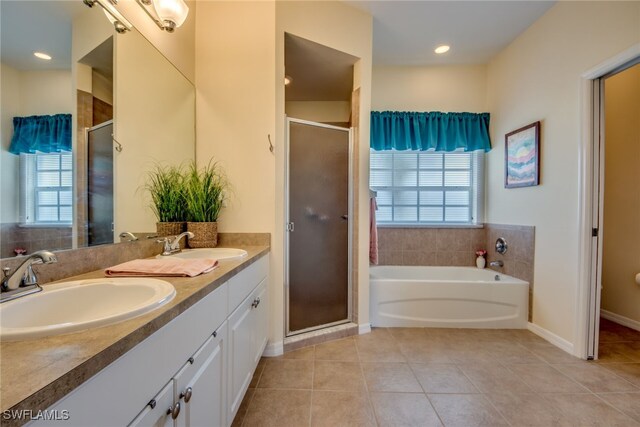 bathroom featuring separate shower and tub, a healthy amount of sunlight, and tile patterned floors