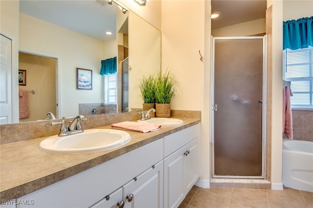 bathroom with separate shower and tub, vanity, and tile patterned flooring