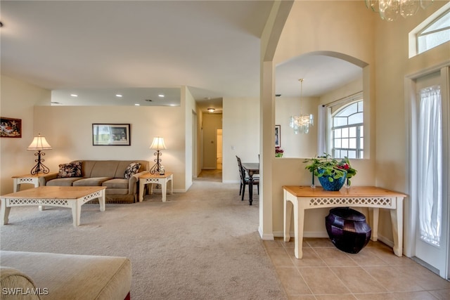 living room with light tile patterned floors and a notable chandelier