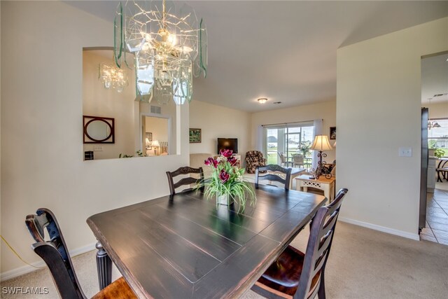 dining area with carpet floors and an inviting chandelier