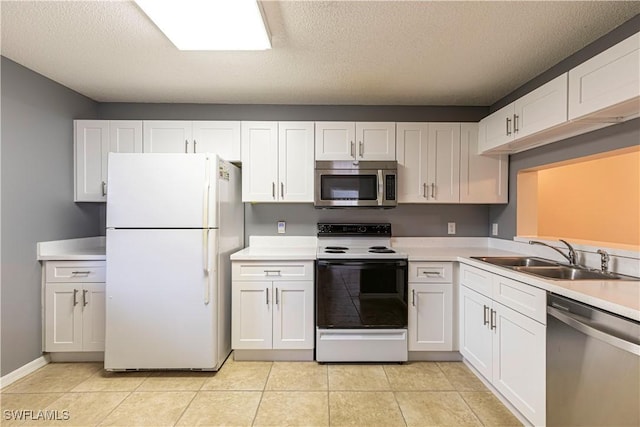 kitchen with stainless steel appliances, sink, white cabinets, and a textured ceiling