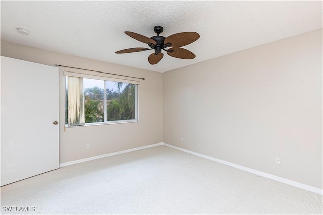 unfurnished room with light colored carpet and ceiling fan