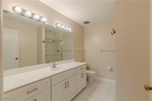 bathroom with vanity, a shower with shower door, tile patterned floors, and toilet