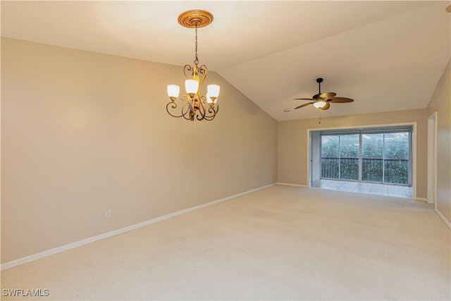 carpeted empty room featuring ceiling fan with notable chandelier and vaulted ceiling