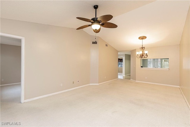 carpeted spare room featuring lofted ceiling and ceiling fan with notable chandelier