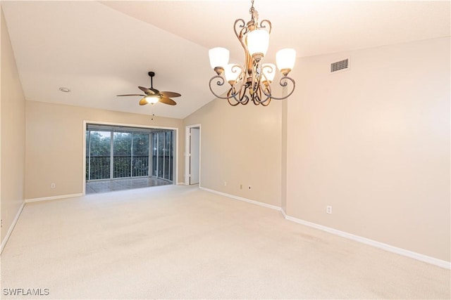 carpeted empty room with ceiling fan with notable chandelier and vaulted ceiling