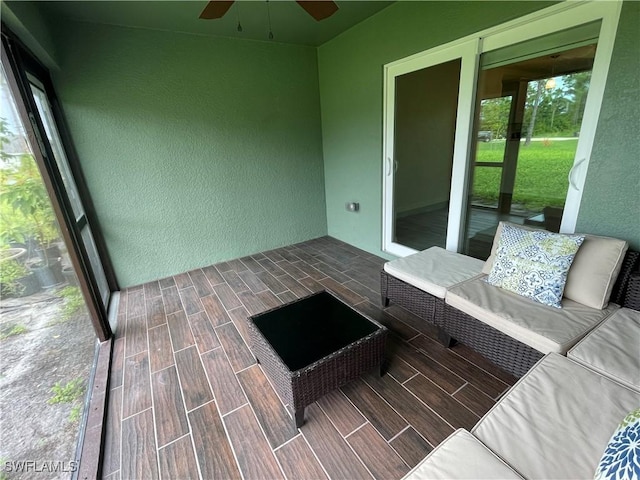 unfurnished sunroom featuring ceiling fan