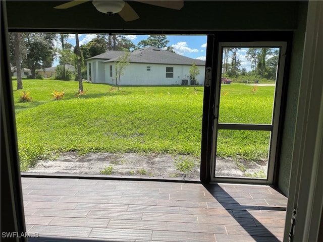 doorway with a wealth of natural light and ceiling fan