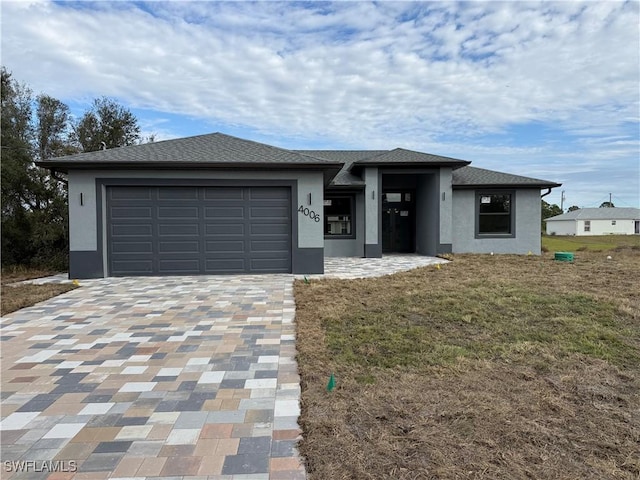 view of front of property featuring a garage and a front lawn