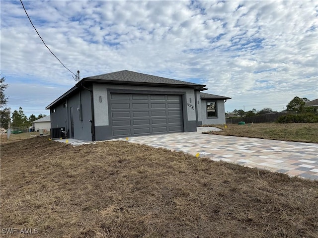 view of front of property with a garage and a front lawn