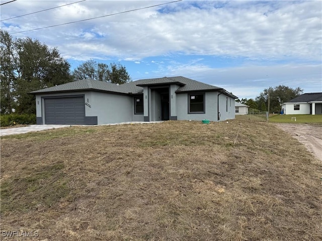 view of front facade featuring a garage and a front lawn