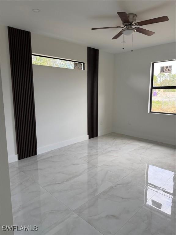 unfurnished room featuring ceiling fan