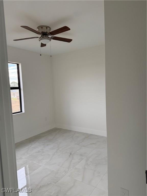 unfurnished room with ceiling fan