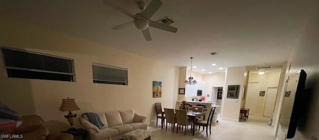 living room featuring ceiling fan with notable chandelier