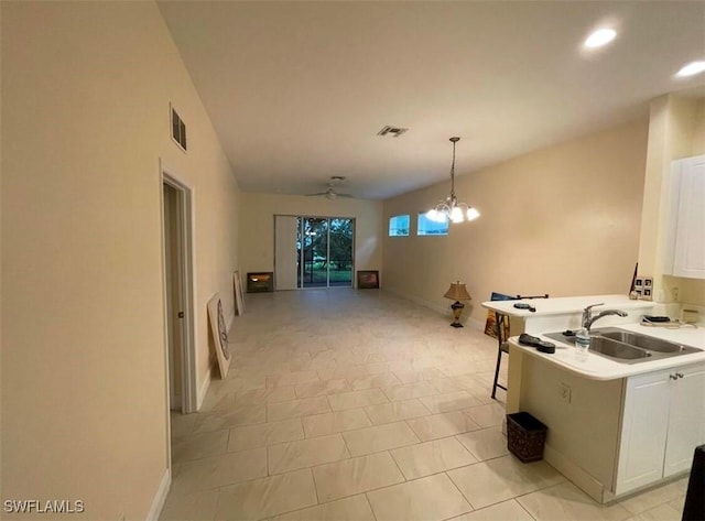 rec room featuring ceiling fan with notable chandelier, light tile patterned floors, and sink