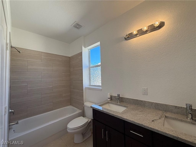 full bathroom featuring toilet, tiled shower / bath, tile patterned floors, and vanity