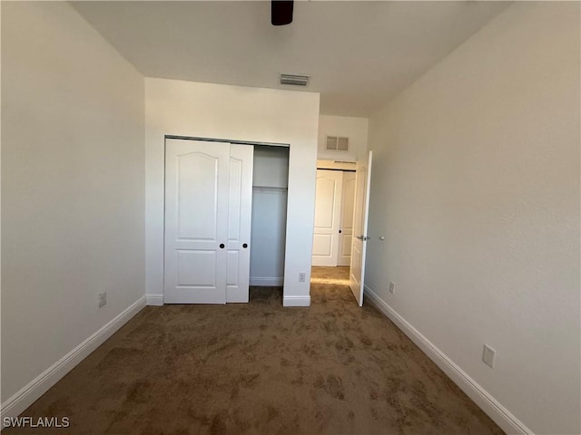 unfurnished bedroom with a closet, ceiling fan, and dark colored carpet