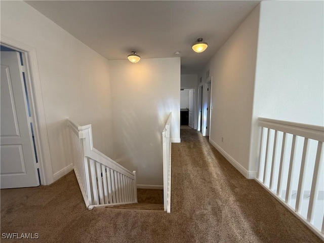 hallway featuring dark carpet