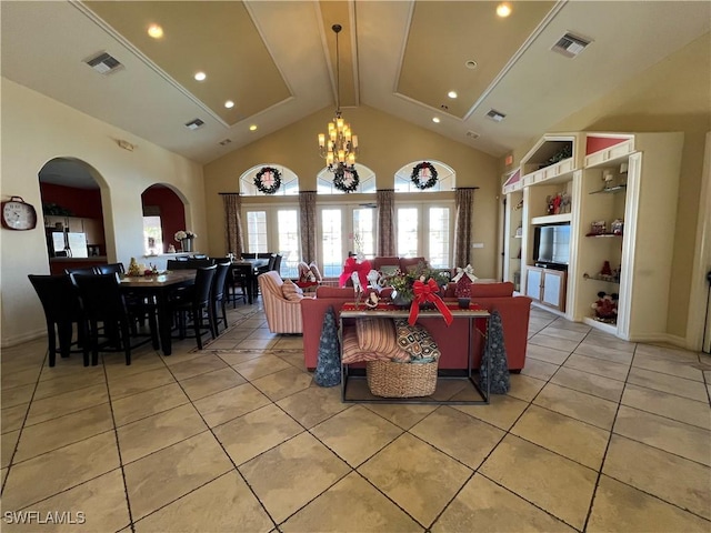 interior space with built in shelves, an inviting chandelier, high vaulted ceiling, and light tile patterned flooring