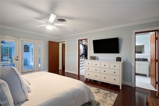 bedroom with a spacious closet, dark hardwood / wood-style floors, a closet, crown molding, and ceiling fan