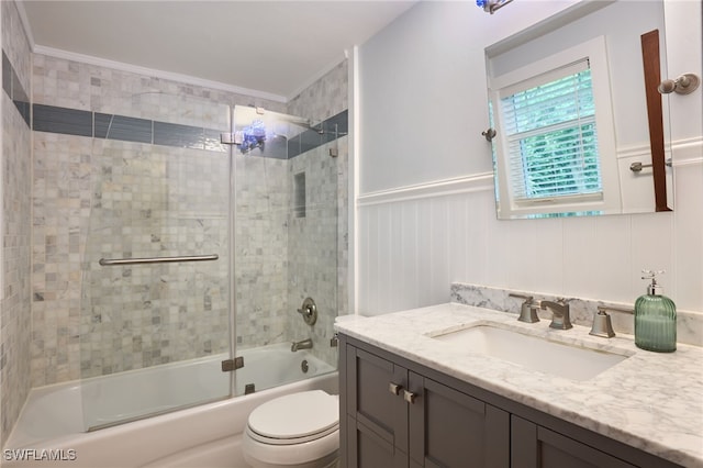 full bathroom featuring toilet, crown molding, bath / shower combo with glass door, and vanity