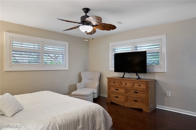 bedroom with ceiling fan and dark hardwood / wood-style flooring