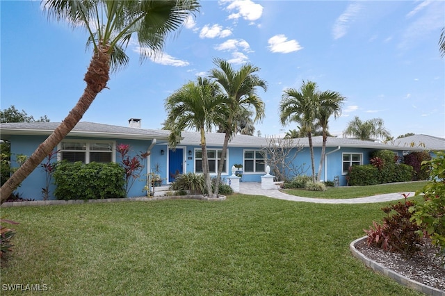 ranch-style house featuring a front lawn