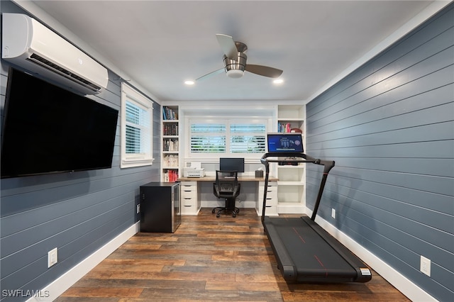 office space featuring a wall mounted air conditioner, ceiling fan, dark hardwood / wood-style flooring, and wood walls