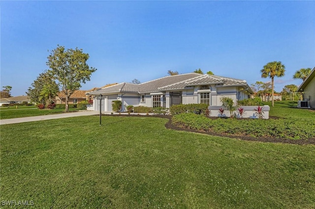 view of front of home featuring central AC unit, a front lawn, and a garage