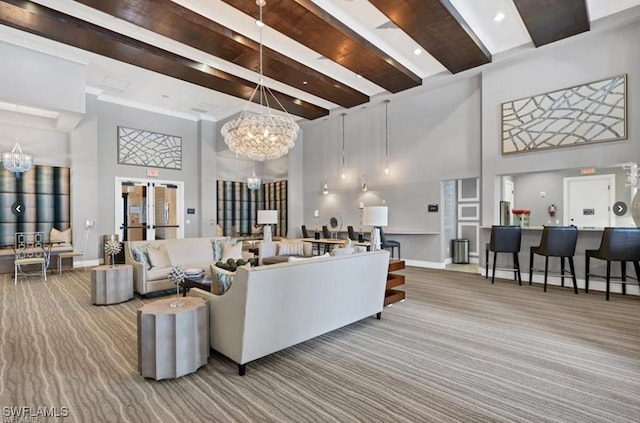 carpeted living room with beam ceiling, a towering ceiling, and an inviting chandelier