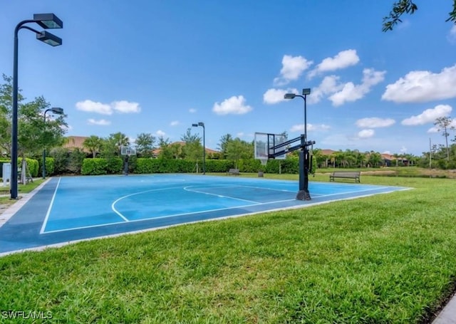 view of sport court featuring a lawn