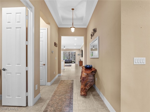 hallway featuring light tile patterned flooring and crown molding