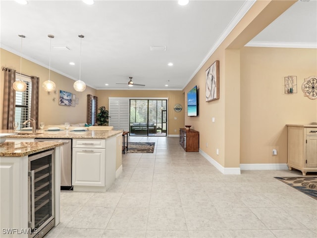 kitchen with light stone countertops, beverage cooler, decorative light fixtures, ceiling fan, and light tile patterned floors