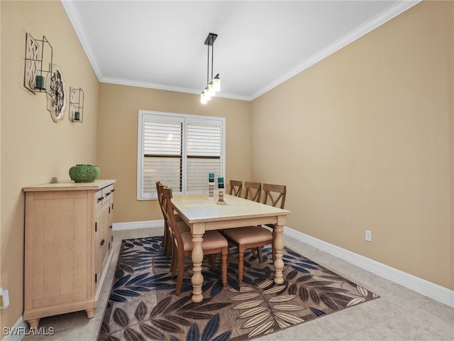 tiled dining space featuring ornamental molding