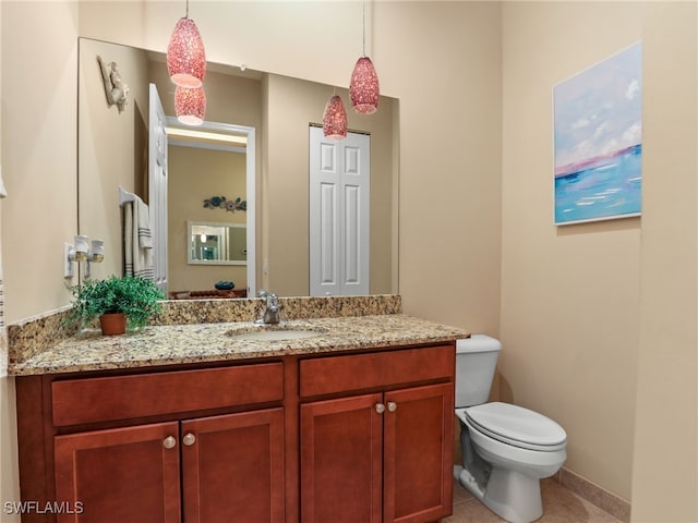 bathroom featuring tile patterned floors, toilet, and vanity