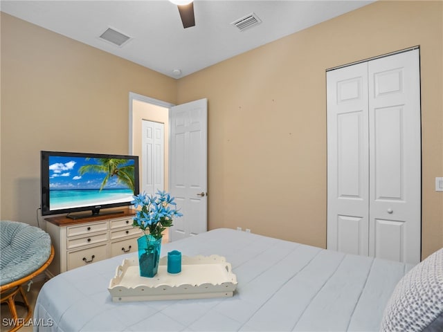 bedroom with ceiling fan and a closet