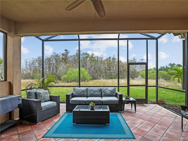 sunroom / solarium featuring ceiling fan