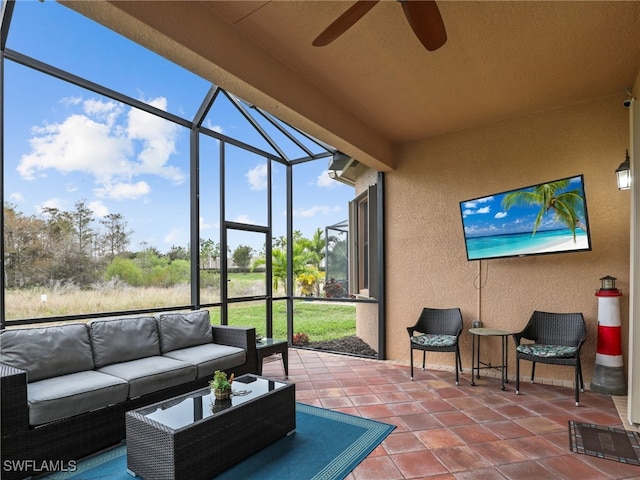 sunroom / solarium featuring ceiling fan