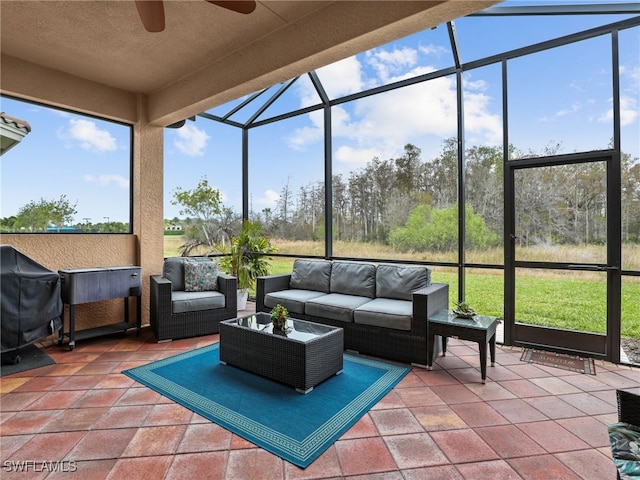 sunroom featuring ceiling fan