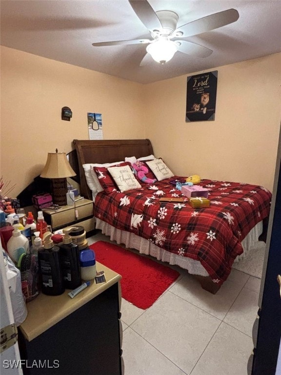 tiled bedroom with ceiling fan