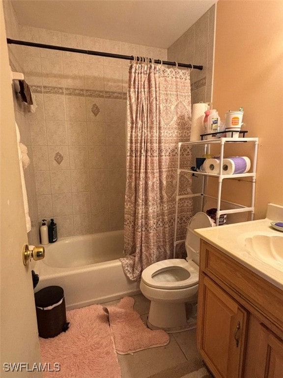 full bathroom featuring vanity, tile patterned floors, shower / bath combo with shower curtain, and toilet