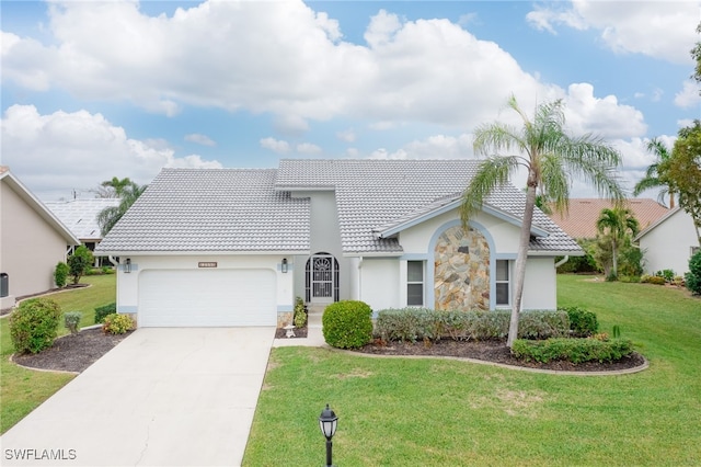 view of front of house with a front yard and a garage