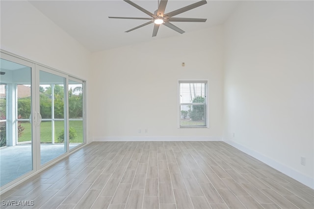 empty room featuring ceiling fan and high vaulted ceiling